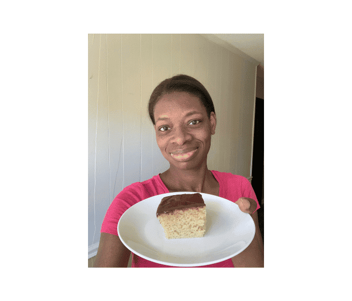 holding a piece of homemade cake